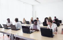 Adult students on laptops