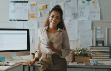Teacher in front of busy desk