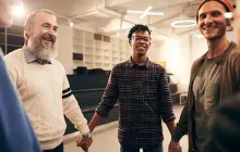 Men holding hands in a support group