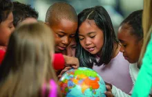 Young schoolchildren looking at a globe