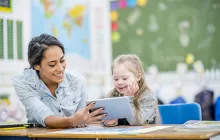 teacher and student looking at ipad