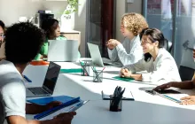 Group of researchers in sunny conference room